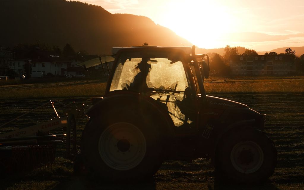 Tractor in the field at sunset